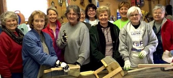 group putting hod baskets together for craft sale