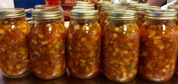 canning jars filled with peach salsa