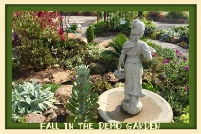 Statue in garden with rocks and low growing plants